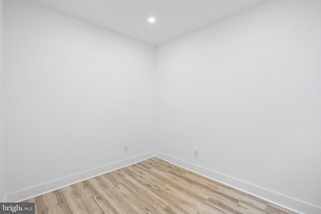 empty room with light hardwood / wood-style flooring