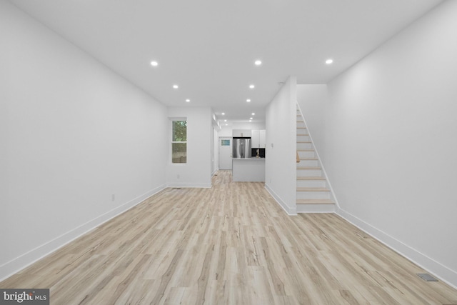 unfurnished living room with light wood-type flooring