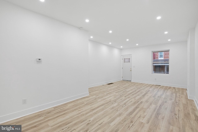 spare room featuring light hardwood / wood-style flooring