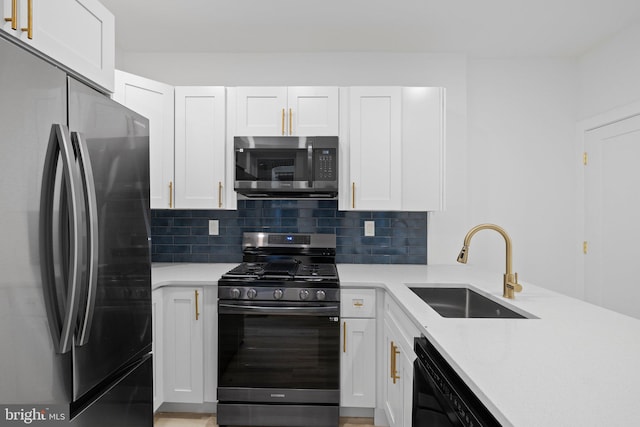 kitchen featuring backsplash, stainless steel appliances, and white cabinets