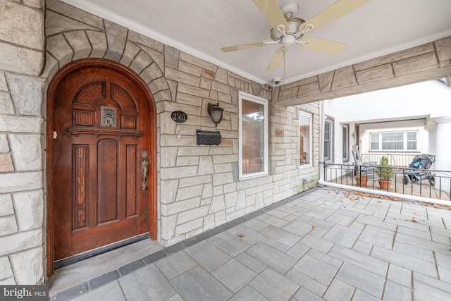 entrance to property with ceiling fan