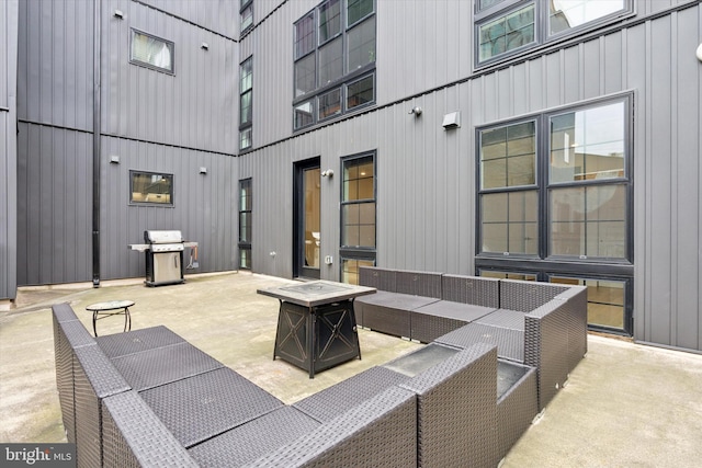 view of patio featuring grilling area and an outdoor living space with a fire pit