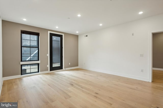 unfurnished room with light wood-type flooring