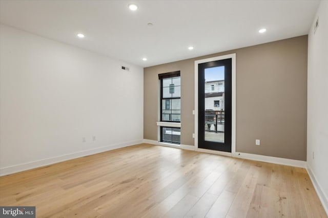 unfurnished room featuring light hardwood / wood-style floors