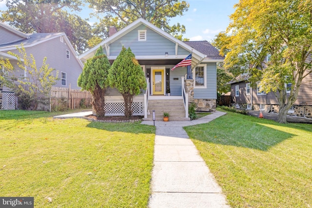 bungalow-style home featuring a front lawn