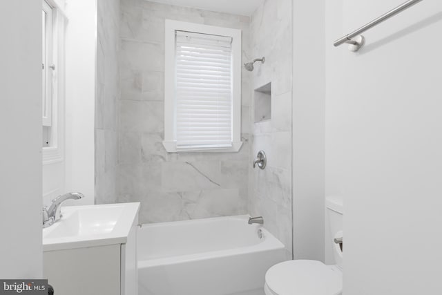 full bathroom with vanity, tiled shower / bath combo, and toilet