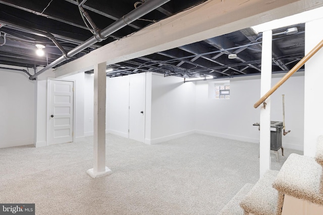 basement featuring light colored carpet