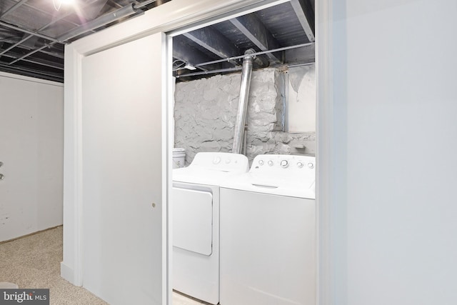 washroom featuring independent washer and dryer and light carpet