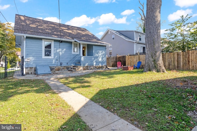 rear view of house with a lawn