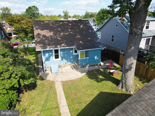 rear view of property with a yard