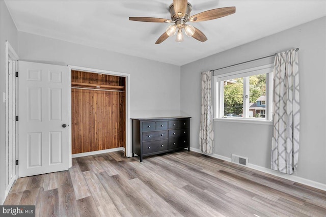 unfurnished bedroom featuring a closet, ceiling fan, and light wood-type flooring