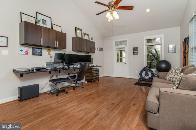 office area featuring light hardwood / wood-style floors, vaulted ceiling, and ceiling fan