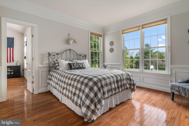 bedroom featuring crown molding and hardwood / wood-style floors