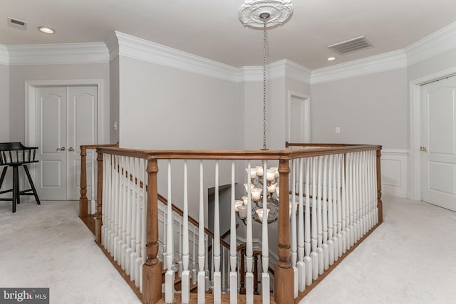 hall with ornamental molding and carpet