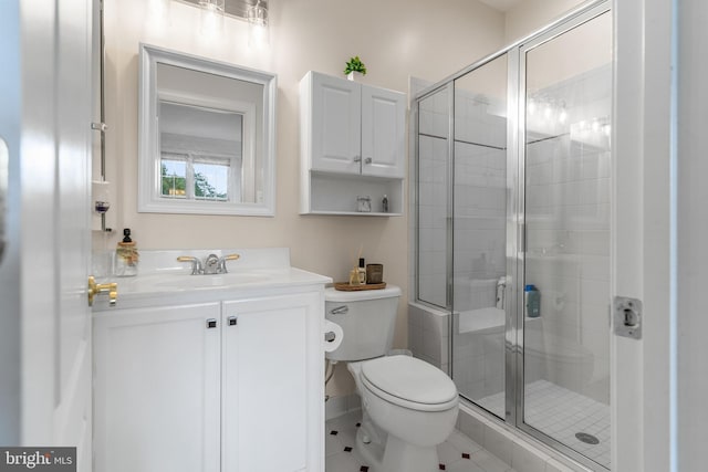 bathroom with walk in shower, vanity, tile patterned flooring, and toilet