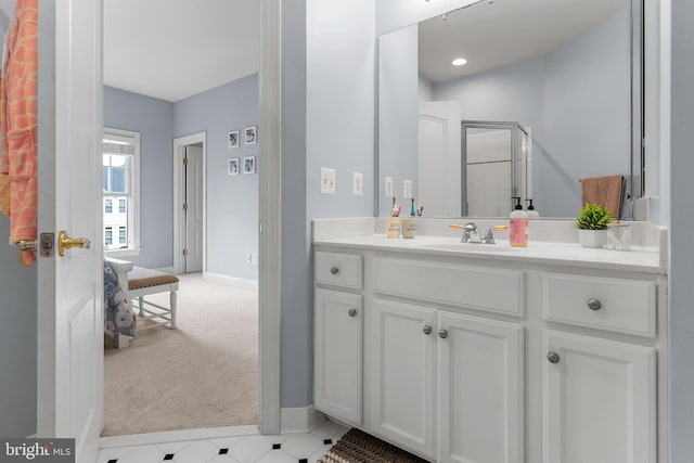 bathroom with walk in shower and vanity