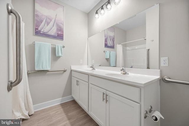 bathroom featuring vanity, hardwood / wood-style flooring, and a shower with curtain