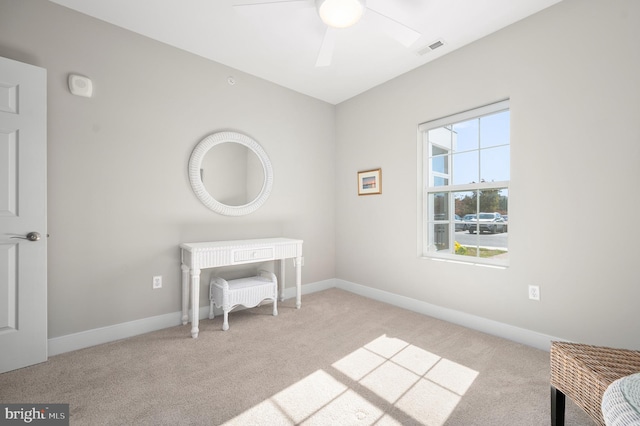 carpeted office with ceiling fan