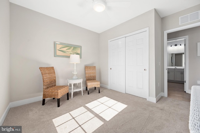 sitting room with light carpet and ceiling fan