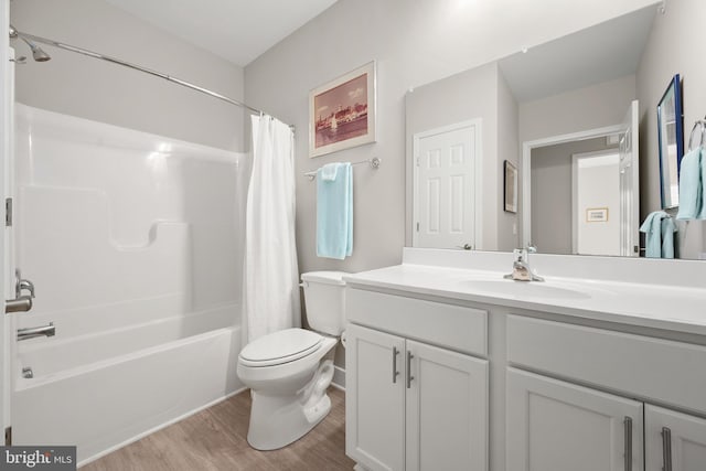 full bathroom with vanity, shower / bath combo, wood-type flooring, and toilet