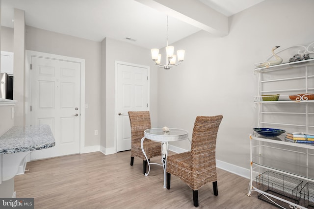 dining space featuring light hardwood / wood-style floors, a notable chandelier, and beam ceiling