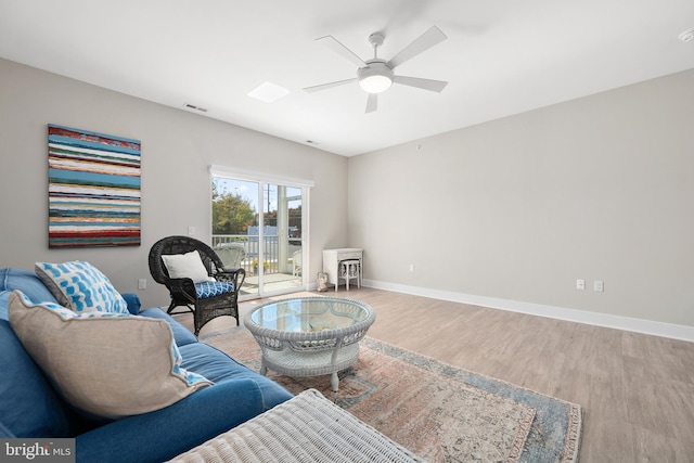 sitting room featuring hardwood / wood-style floors and ceiling fan