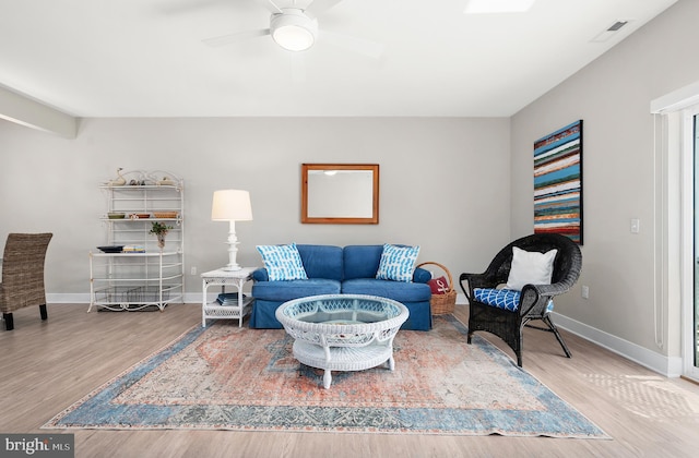 living room featuring hardwood / wood-style floors and ceiling fan