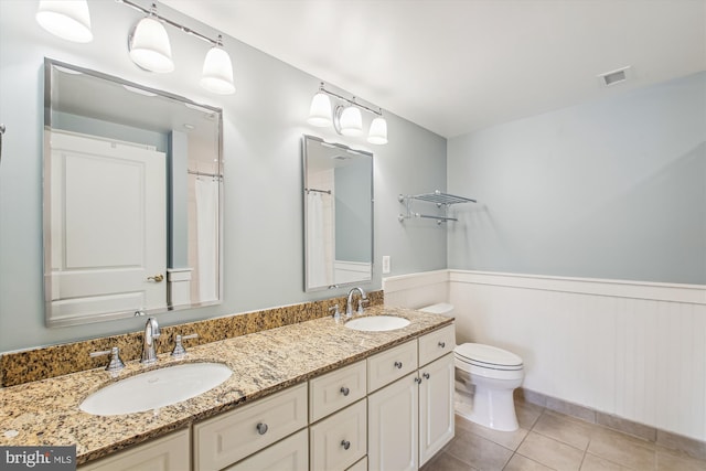 bathroom with vanity, toilet, and tile patterned floors