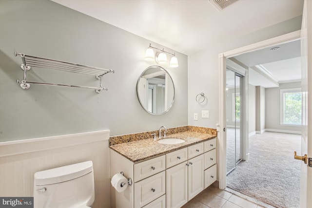 bathroom with tile patterned floors, vanity, and toilet