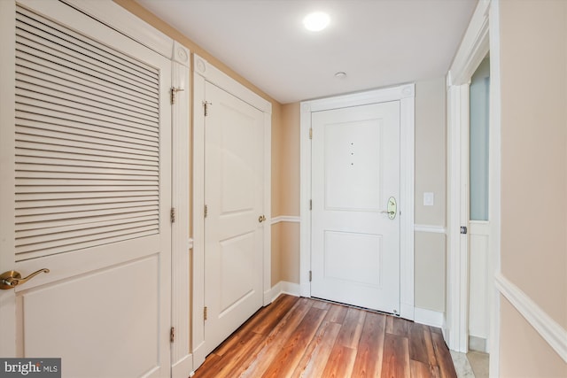 hallway with dark hardwood / wood-style floors