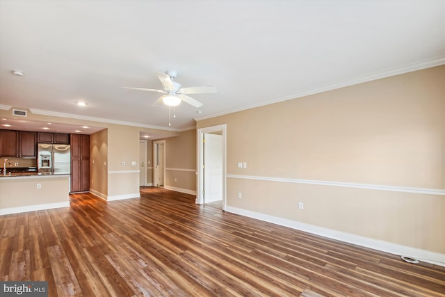 unfurnished living room with ornamental molding, ceiling fan, sink, and dark hardwood / wood-style flooring