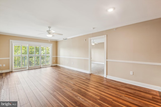 empty room featuring ceiling fan, hardwood / wood-style flooring, and ornamental molding