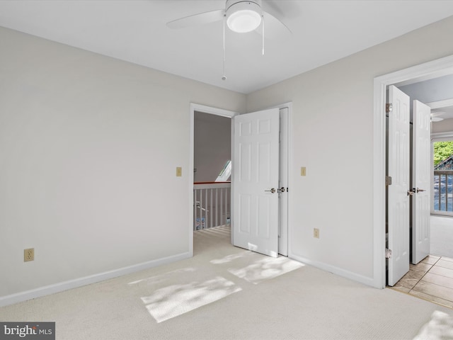 unfurnished bedroom with light carpet and ceiling fan