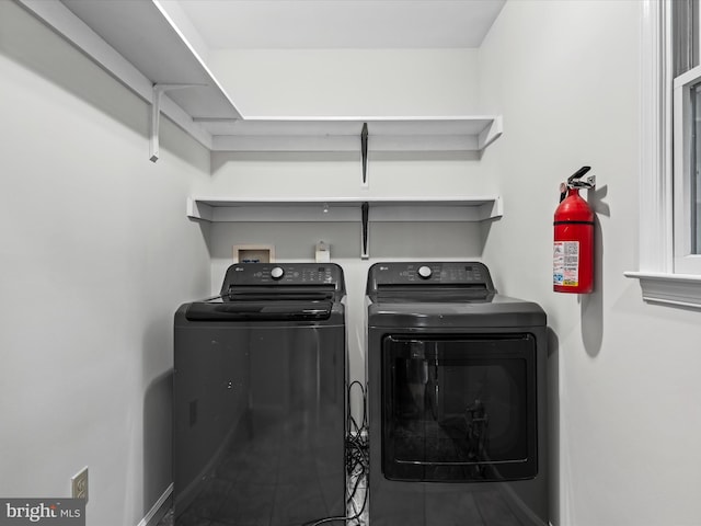 clothes washing area with independent washer and dryer