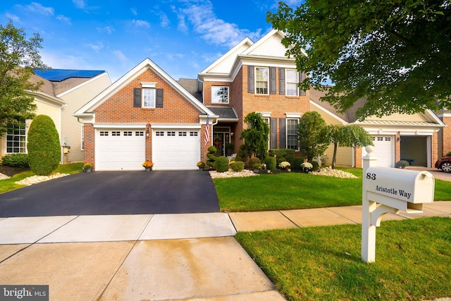 view of front of property with a front yard and a garage