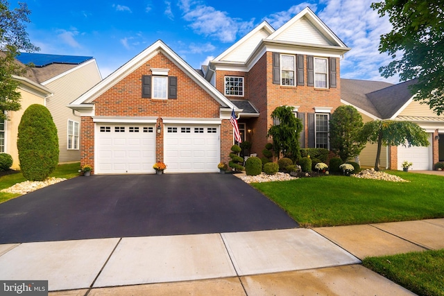 view of front of property with a front yard and a garage