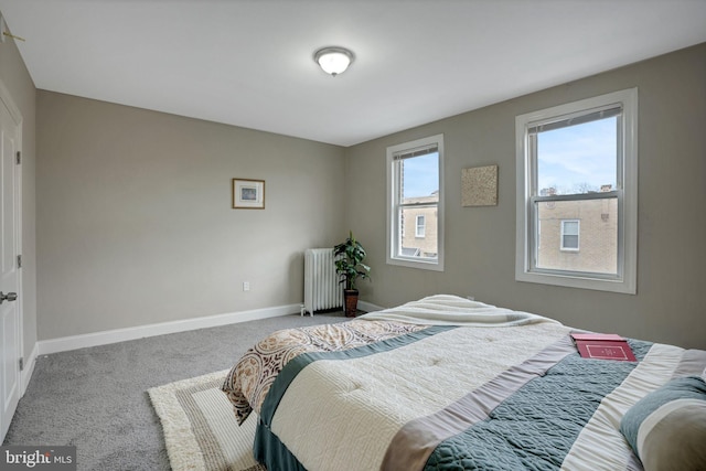 bedroom featuring radiator and carpet