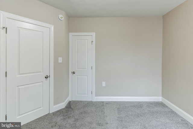 spare room featuring light carpet