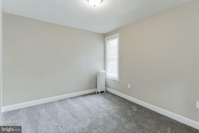 carpeted spare room with radiator heating unit