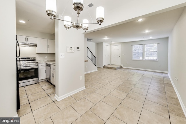 kitchen featuring an inviting chandelier, white cabinetry, light tile patterned flooring, decorative light fixtures, and stainless steel appliances