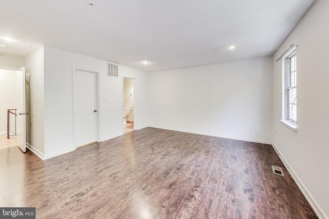 spare room featuring dark wood-type flooring