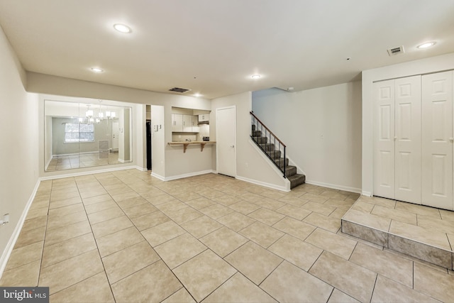 interior space featuring an inviting chandelier and light tile patterned floors