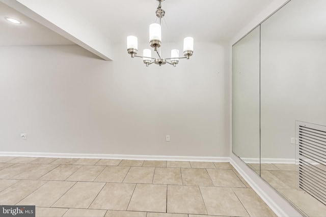 unfurnished dining area featuring a chandelier and light tile patterned floors