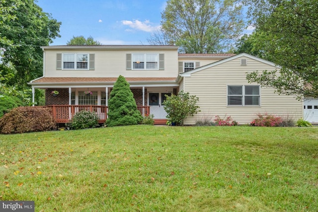 view of front property featuring a front yard and covered porch