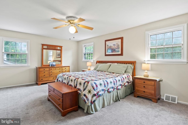 bedroom featuring light carpet and ceiling fan