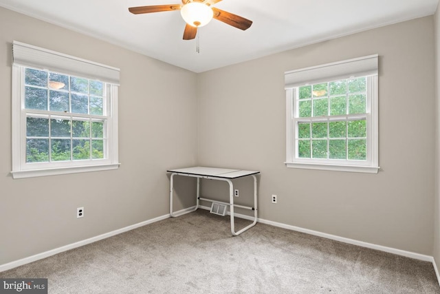 unfurnished room with ceiling fan and carpet