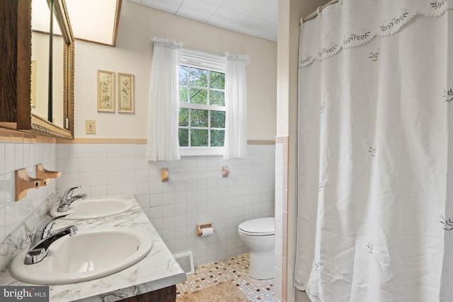 bathroom with tile walls, vanity, tile patterned flooring, toilet, and a shower with curtain