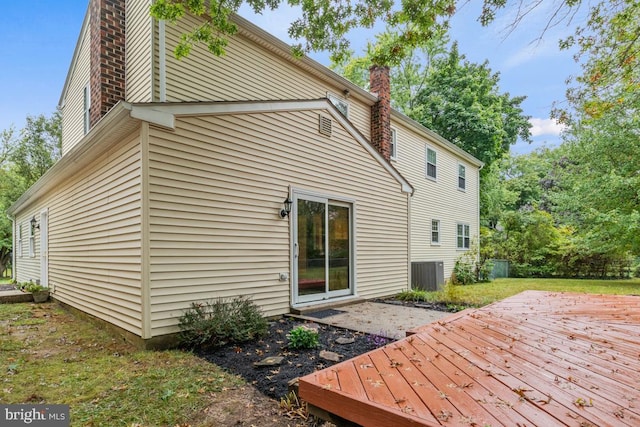 back of house featuring a deck and central AC