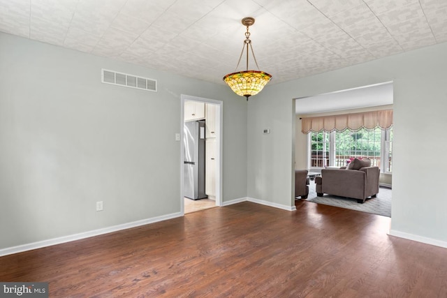 spare room with dark hardwood / wood-style floors