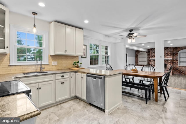 kitchen with white cabinets, sink, a healthy amount of sunlight, and stainless steel dishwasher